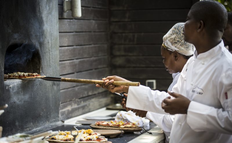Chefs preparing pizza at Abu Camp, Botswana